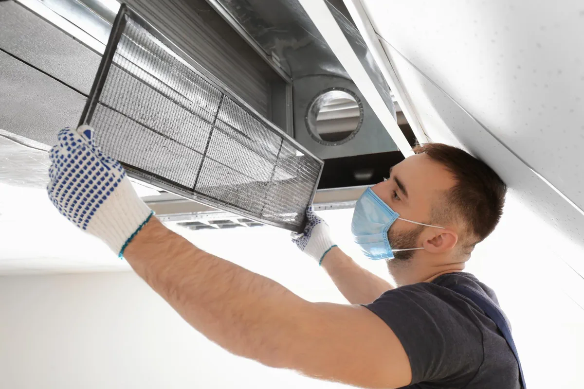 Technician inspecting an air-conditioning filter